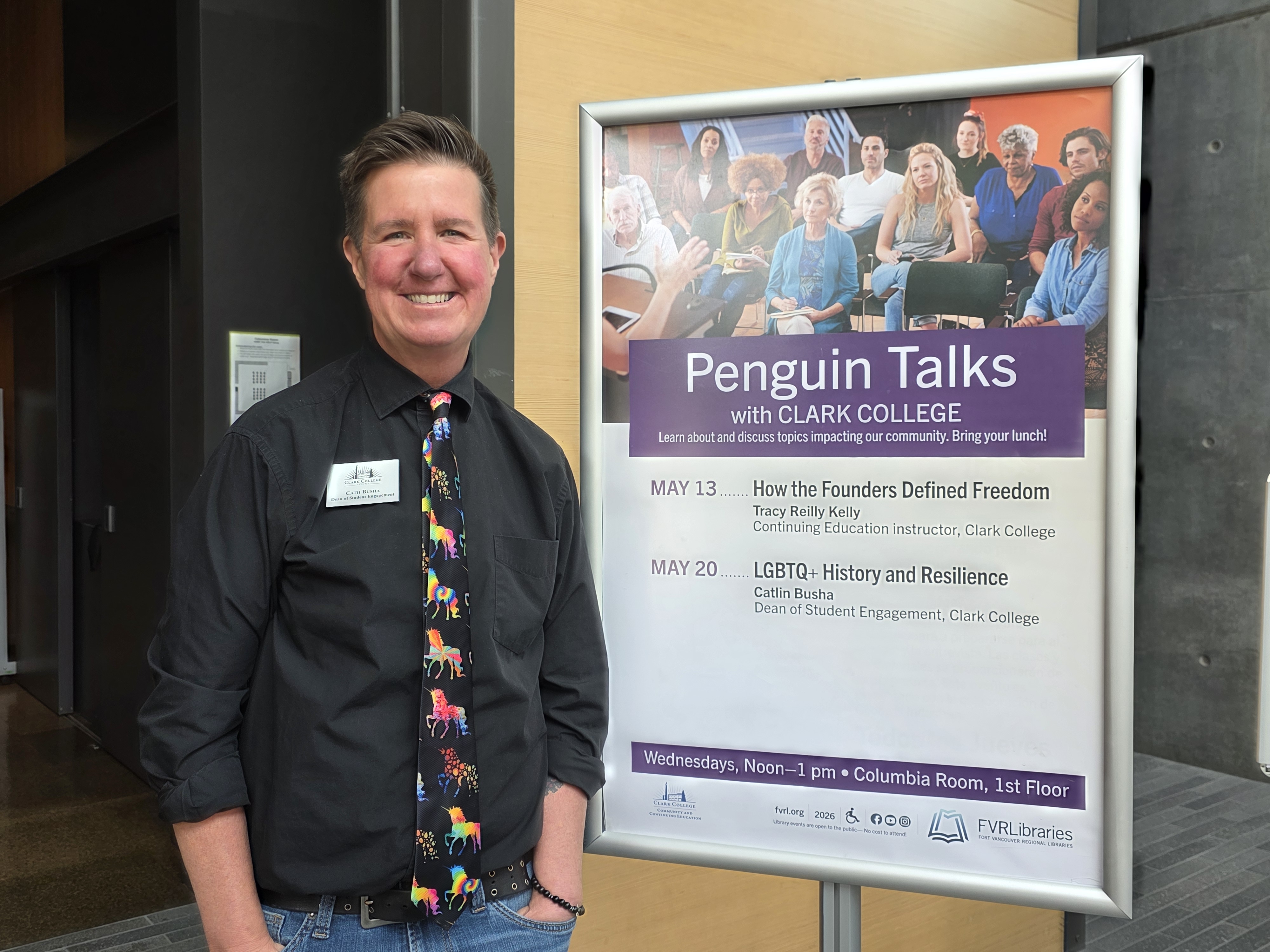 Cath Busha stands in front of a sign announcing Penguin Talks