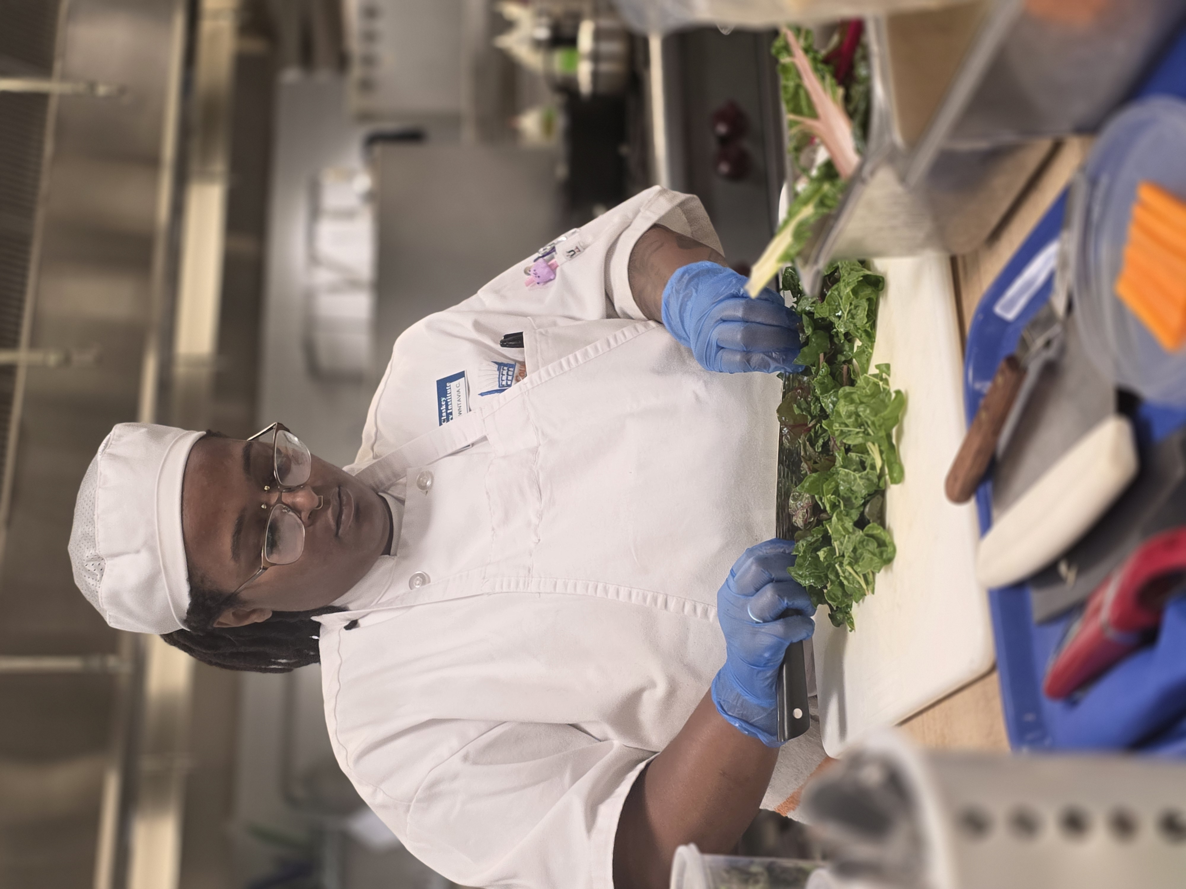Culinary student chopping vegetables