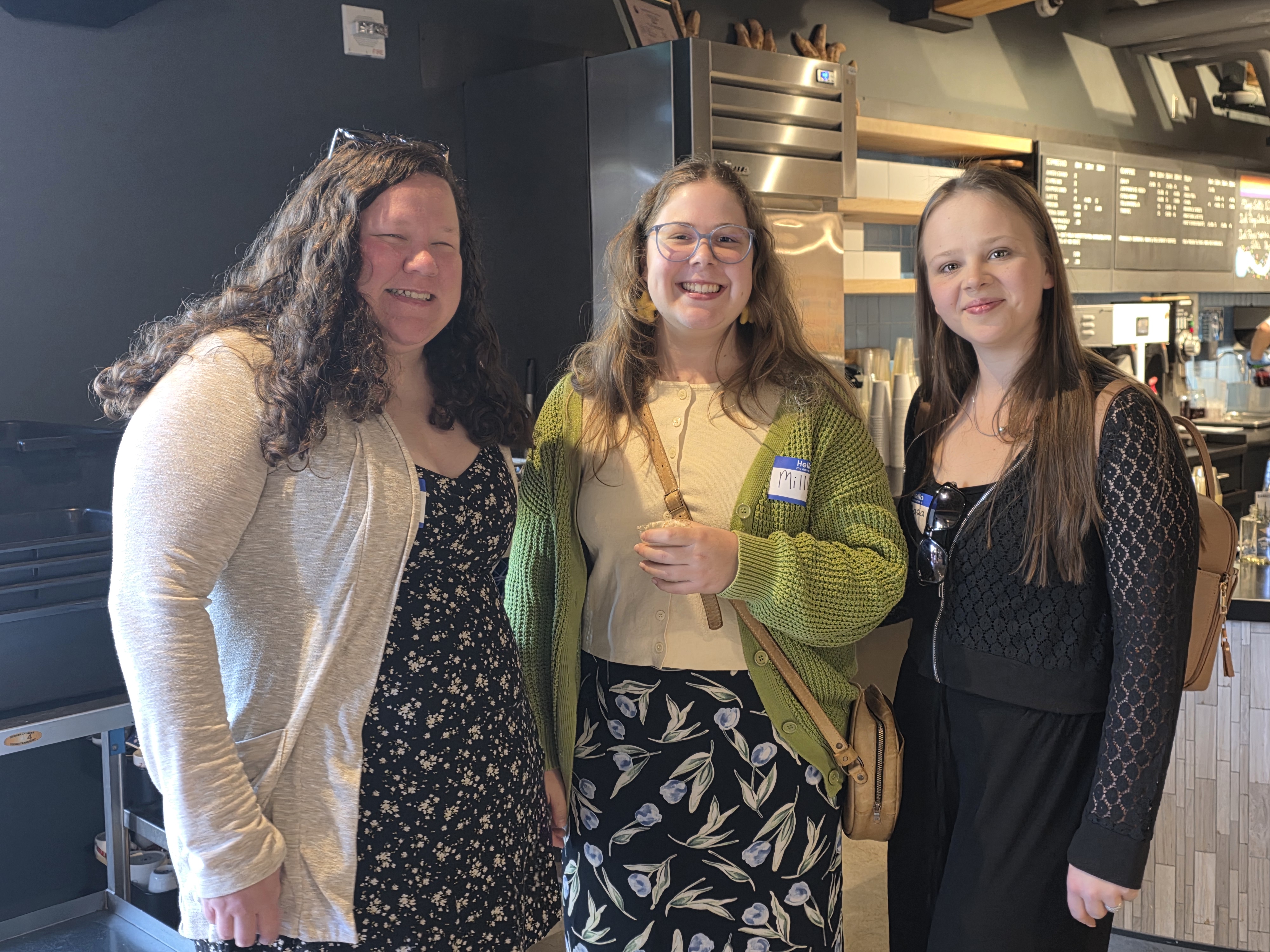 Three culinary alumni smile while chatting at event