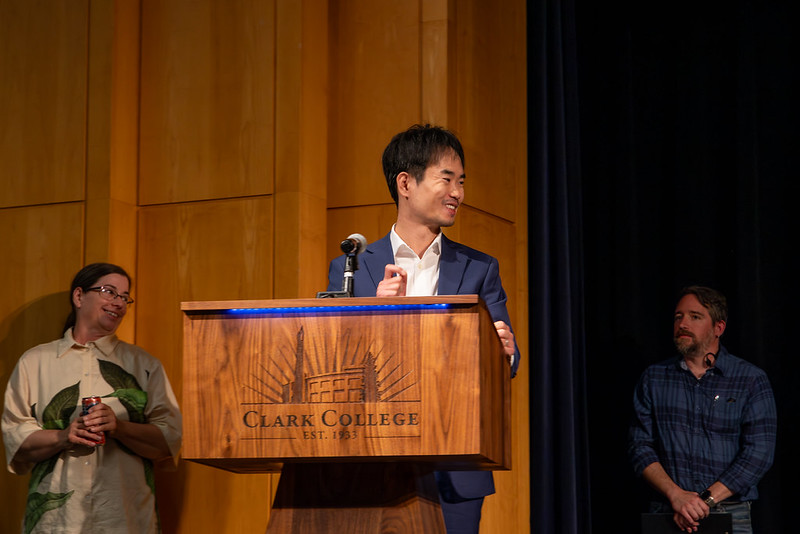 Bo Li speaking at the podium during tenure reception