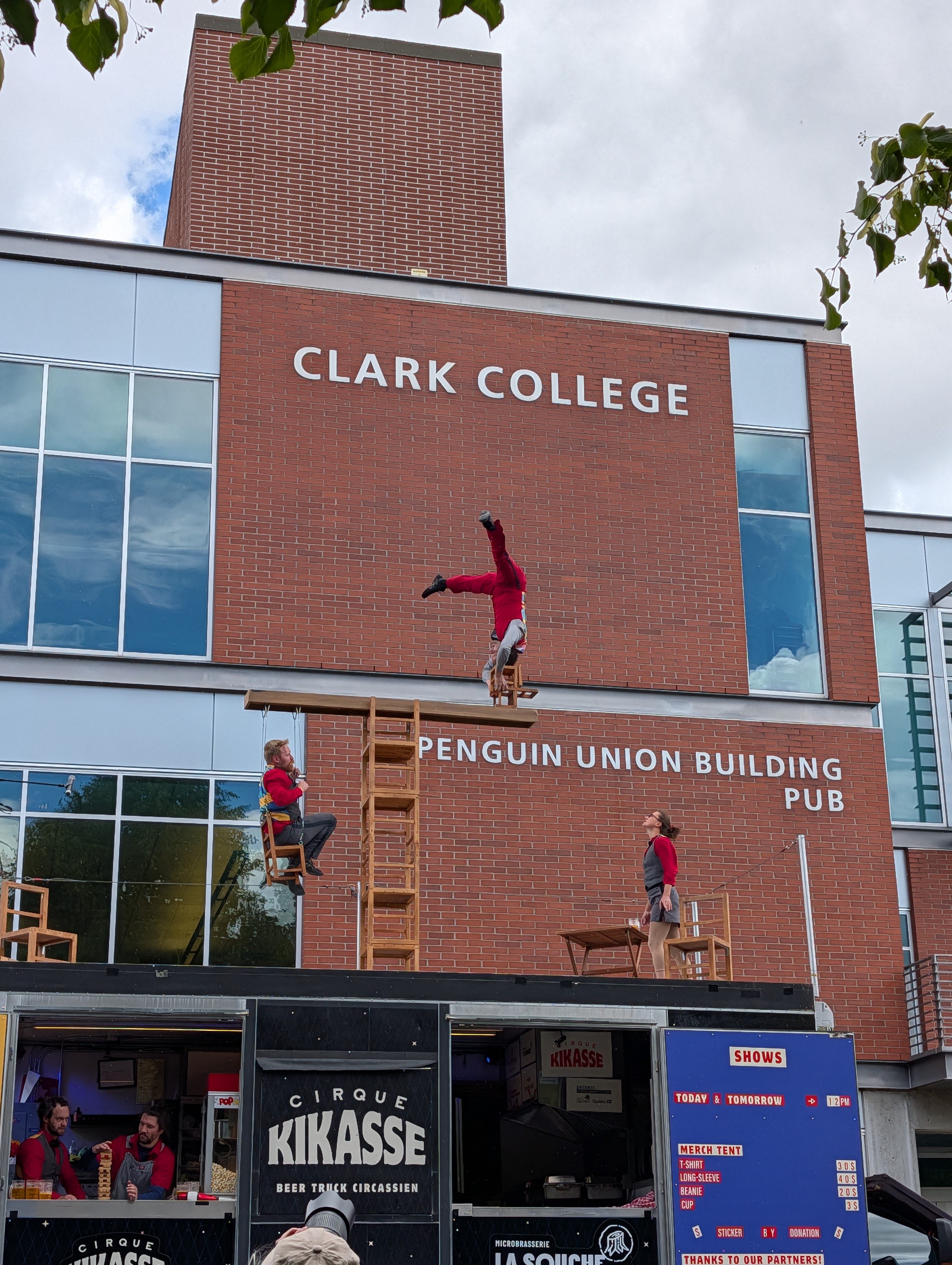 Cirque Kikasse performers performing on top of food truck on Clark's campus