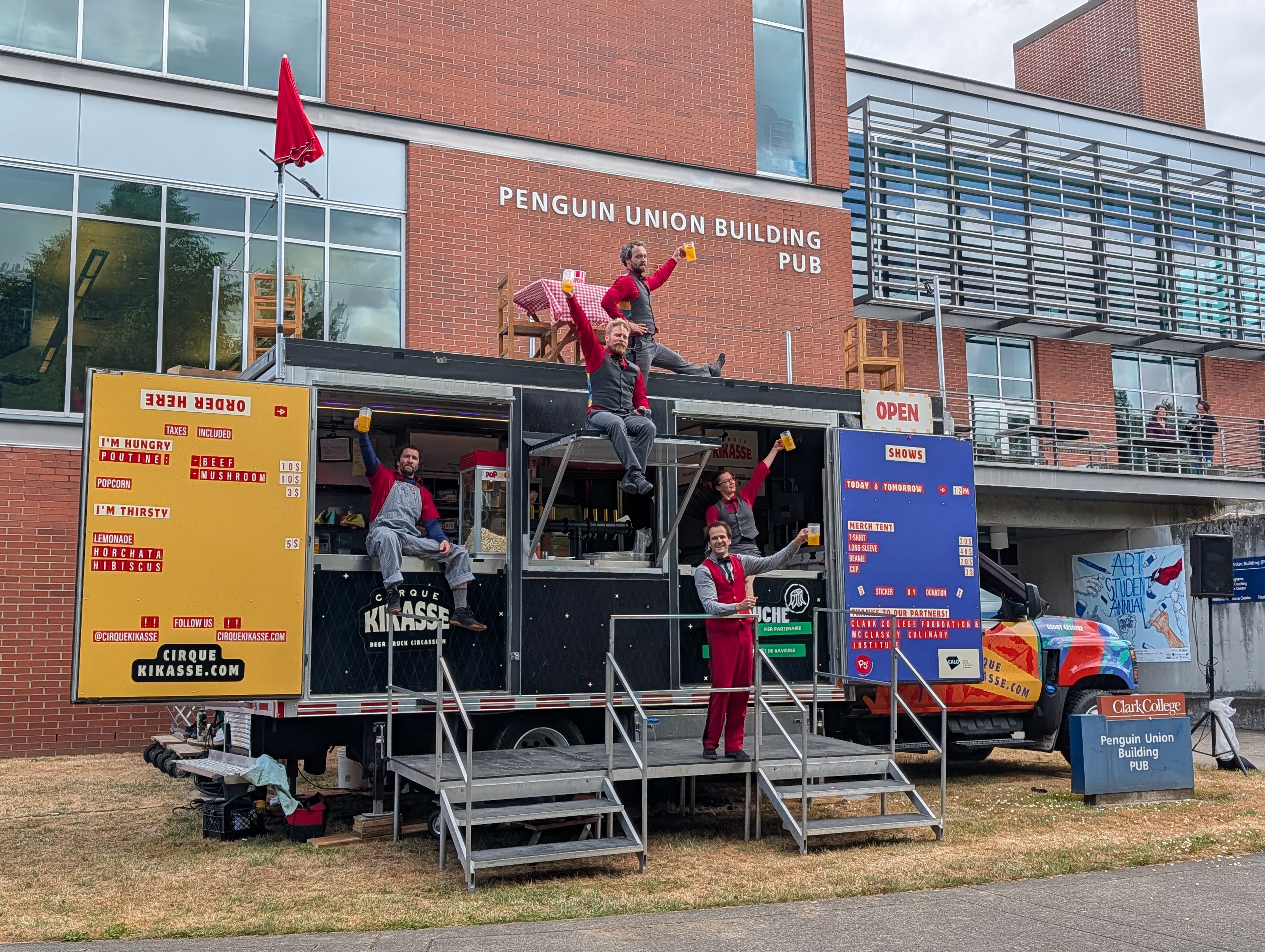 Cirque Kikasse performers with their food truck on Clark's campus