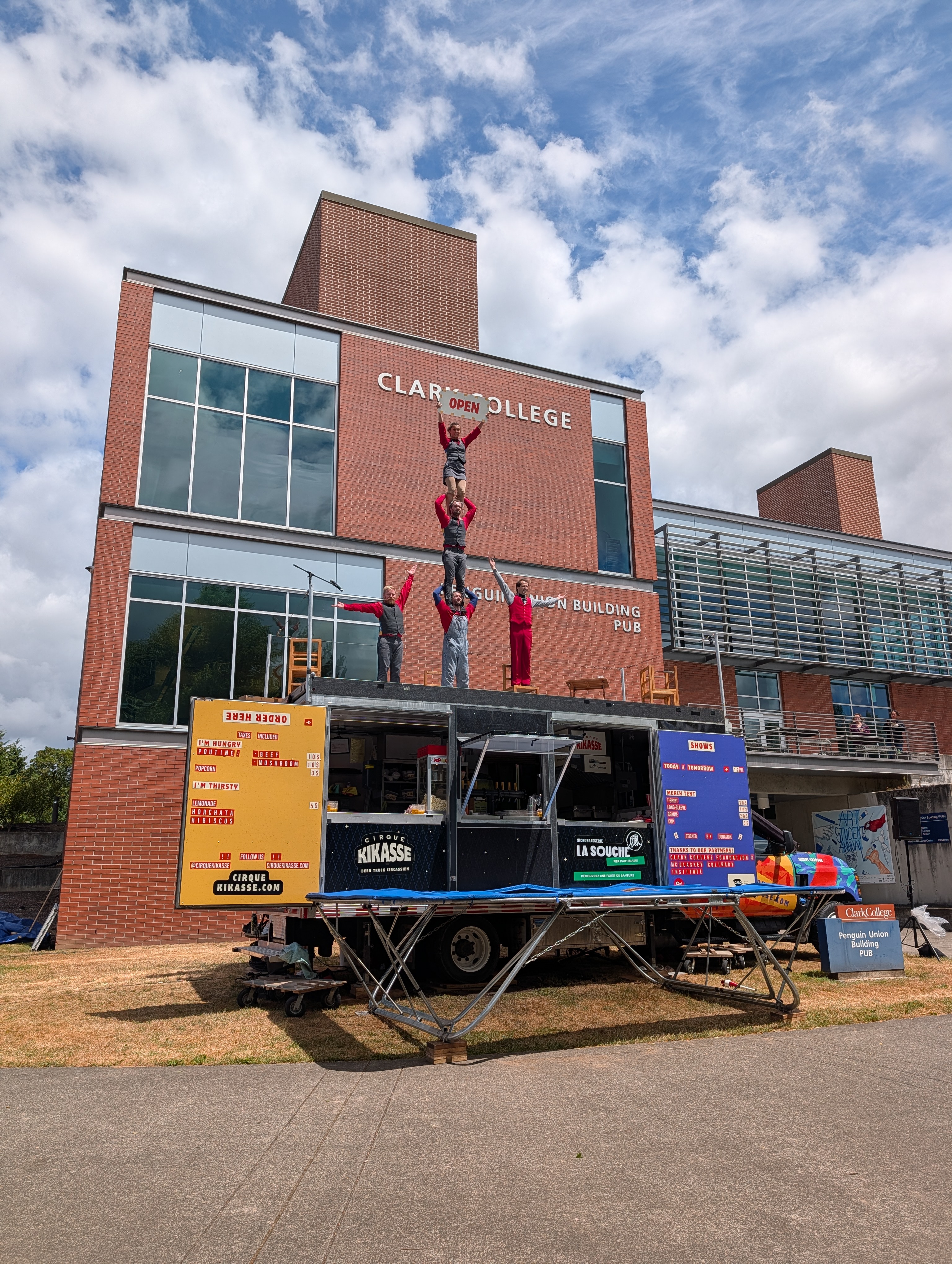 Cirque Kikasse performers perform on top of food truck on Clark's campus