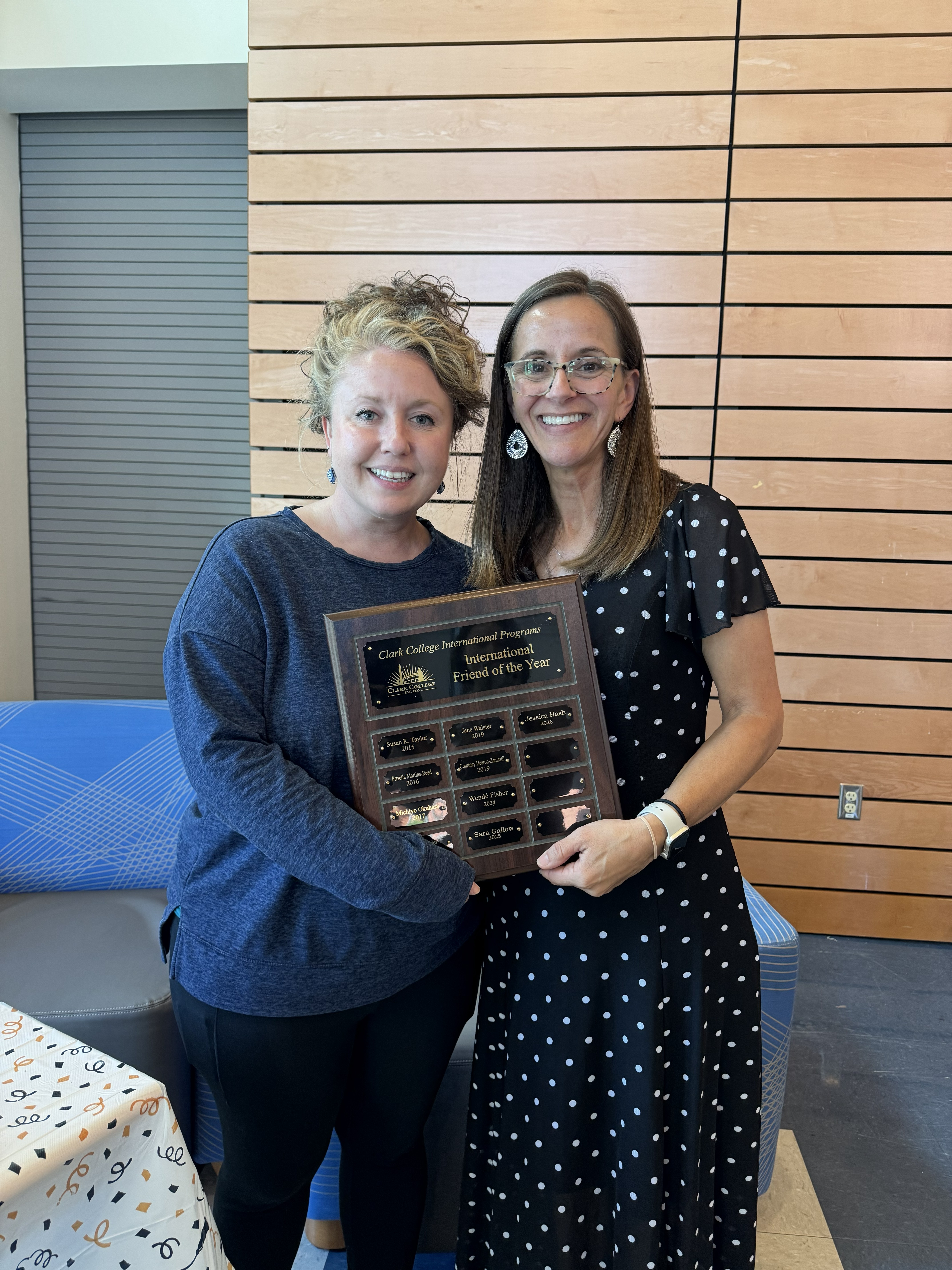 Friend of the Year award recipient holding a plaque