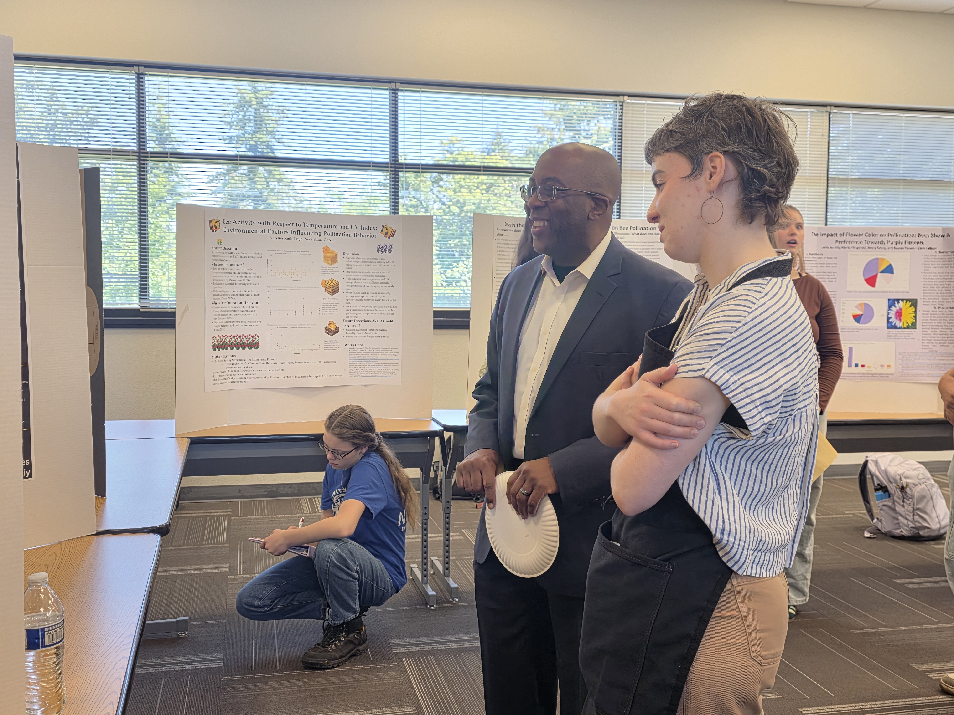 Dr. Terry Brown discusses a poster with biology student