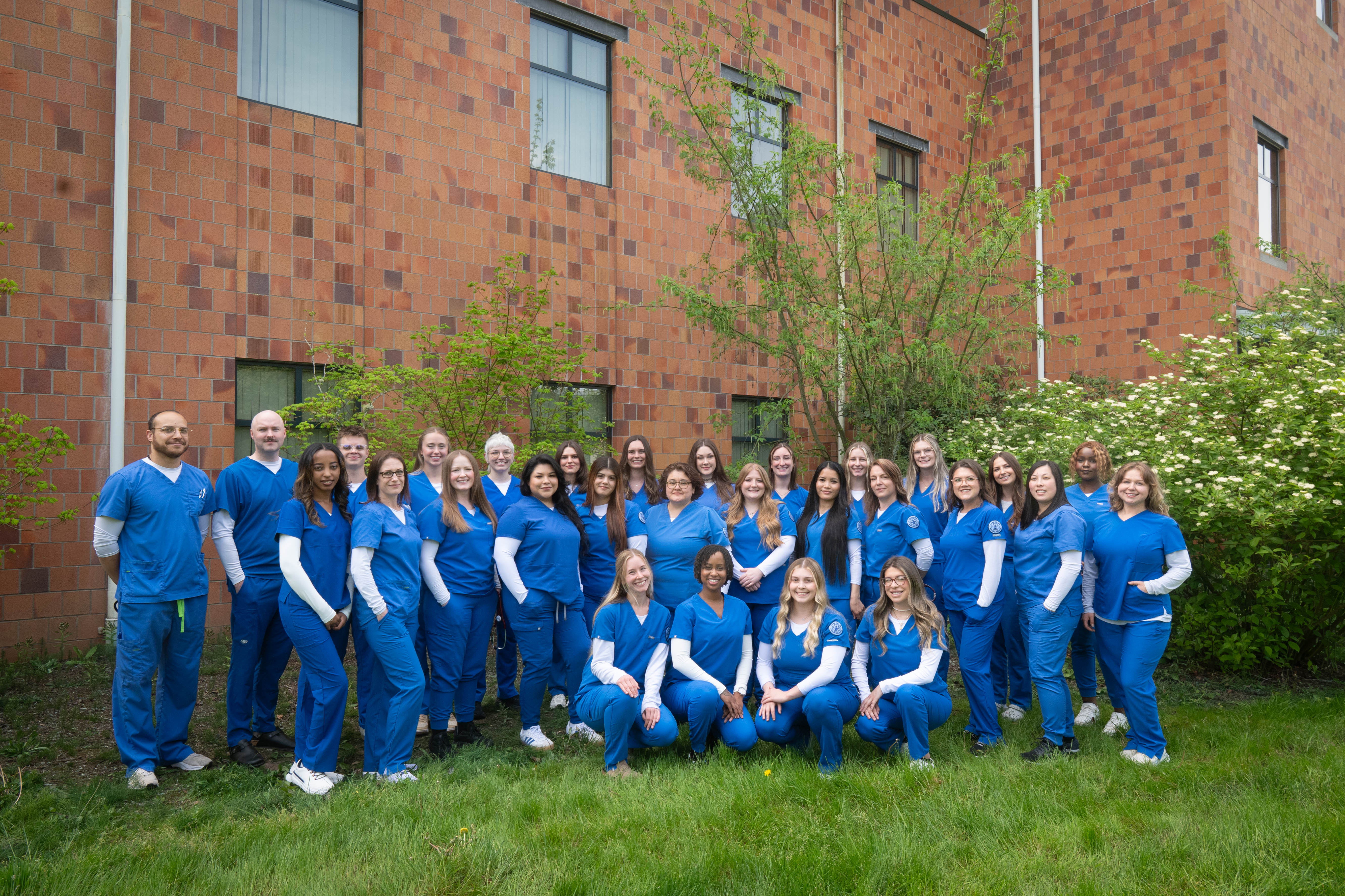 Nurse graduates in blue scrubs