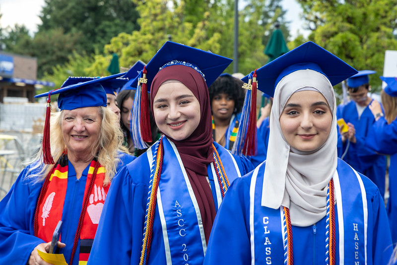 Graduates smile at the camera before processional march