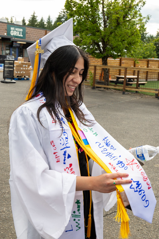 Cynthia Garcia showing her stole to fellow graduates
