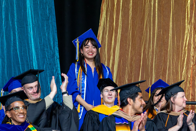 Camille Villaneuva standing on stage during Commencement