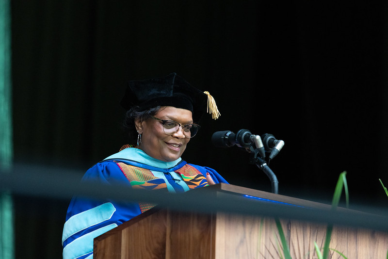 Dr. Karin Edwards at the podium during Commencement