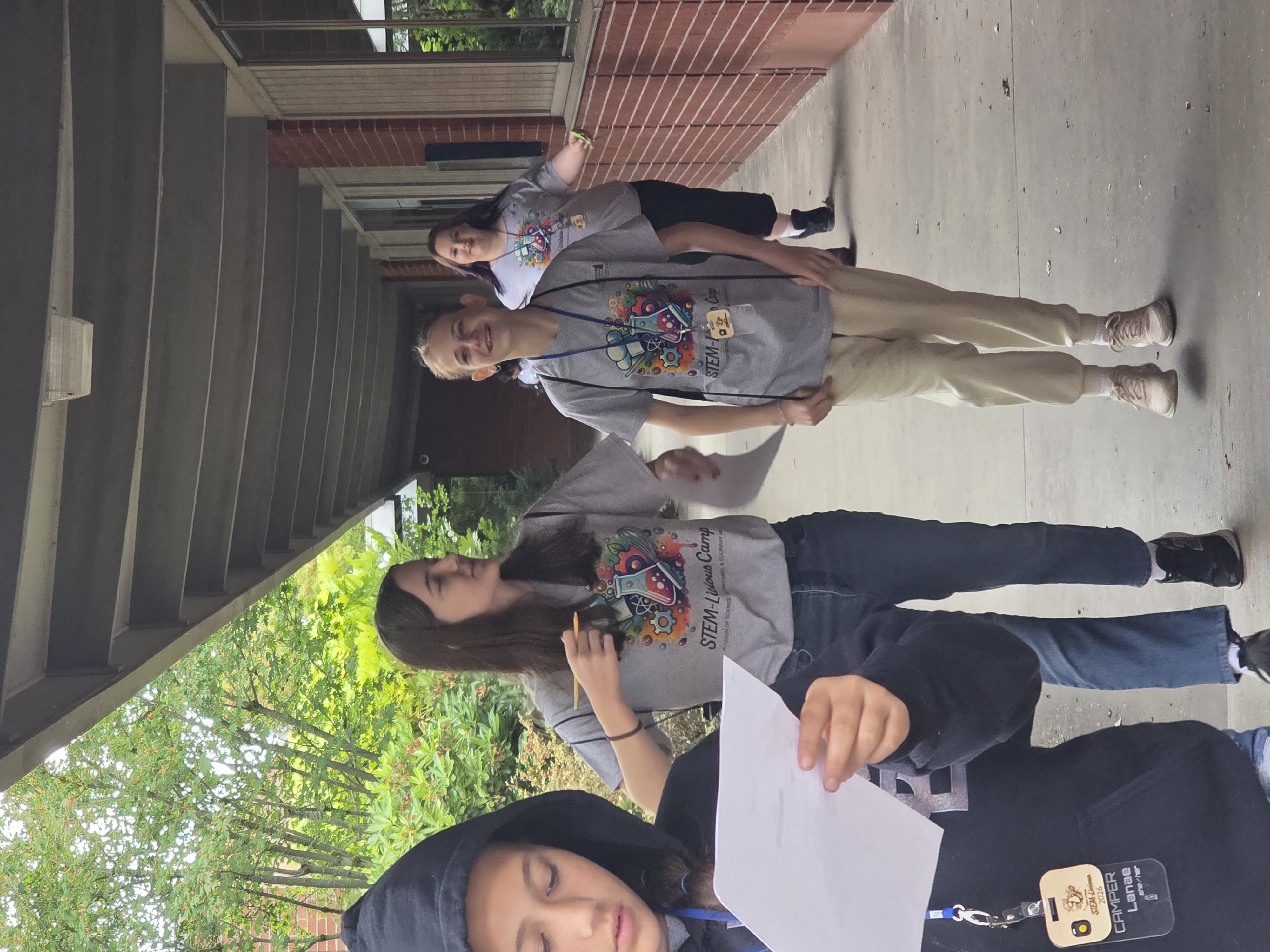 Students laughing while walking outside an academic building