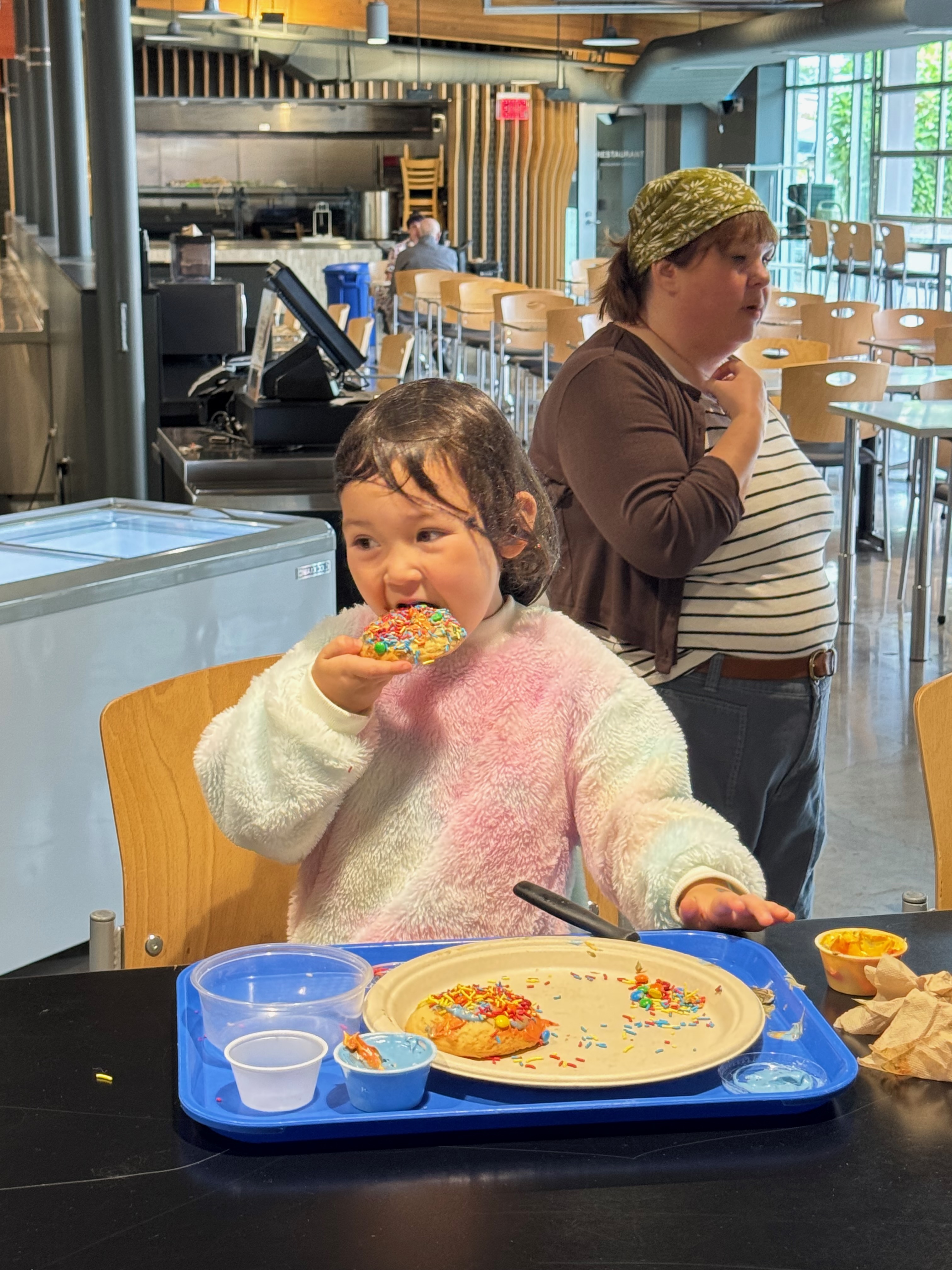 Little girl smiles while eating a cookie