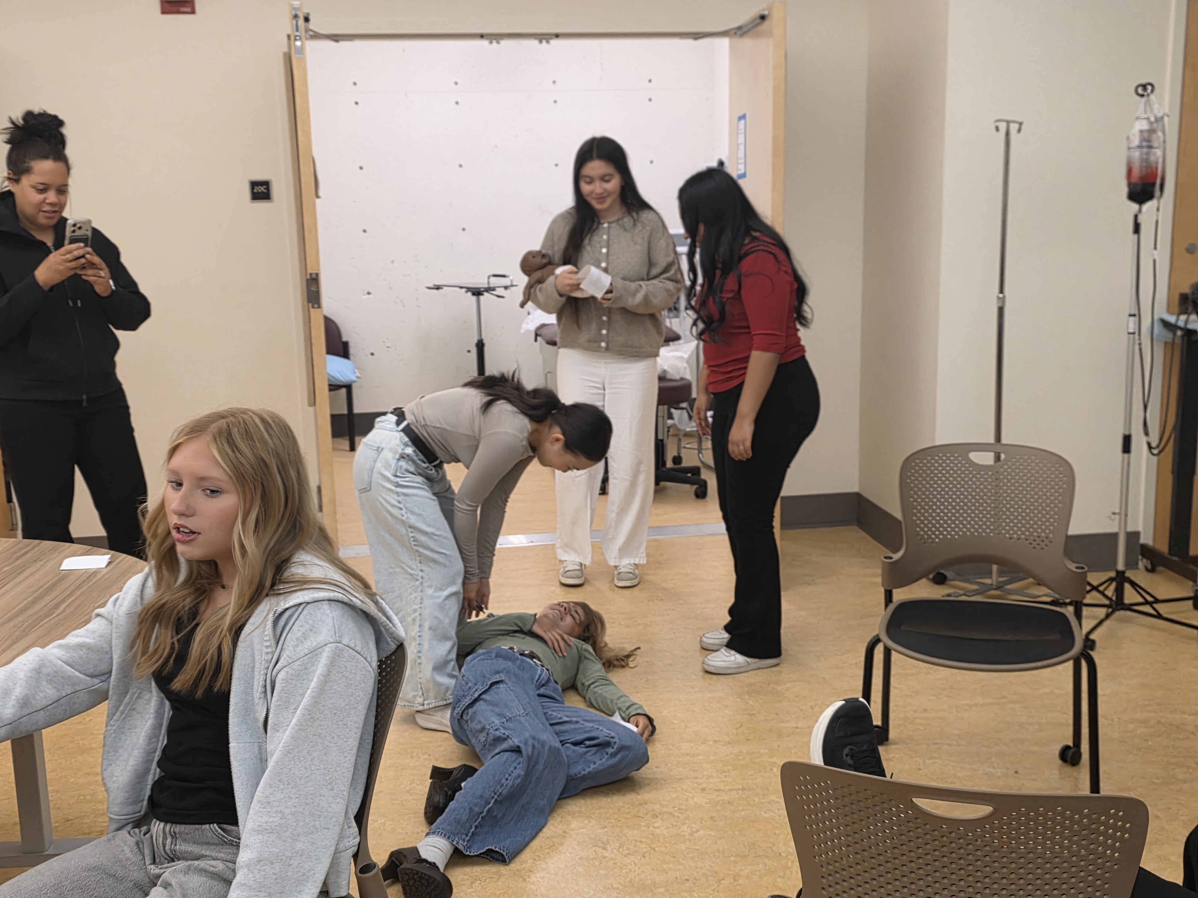 Students participating in an emergency room simulation