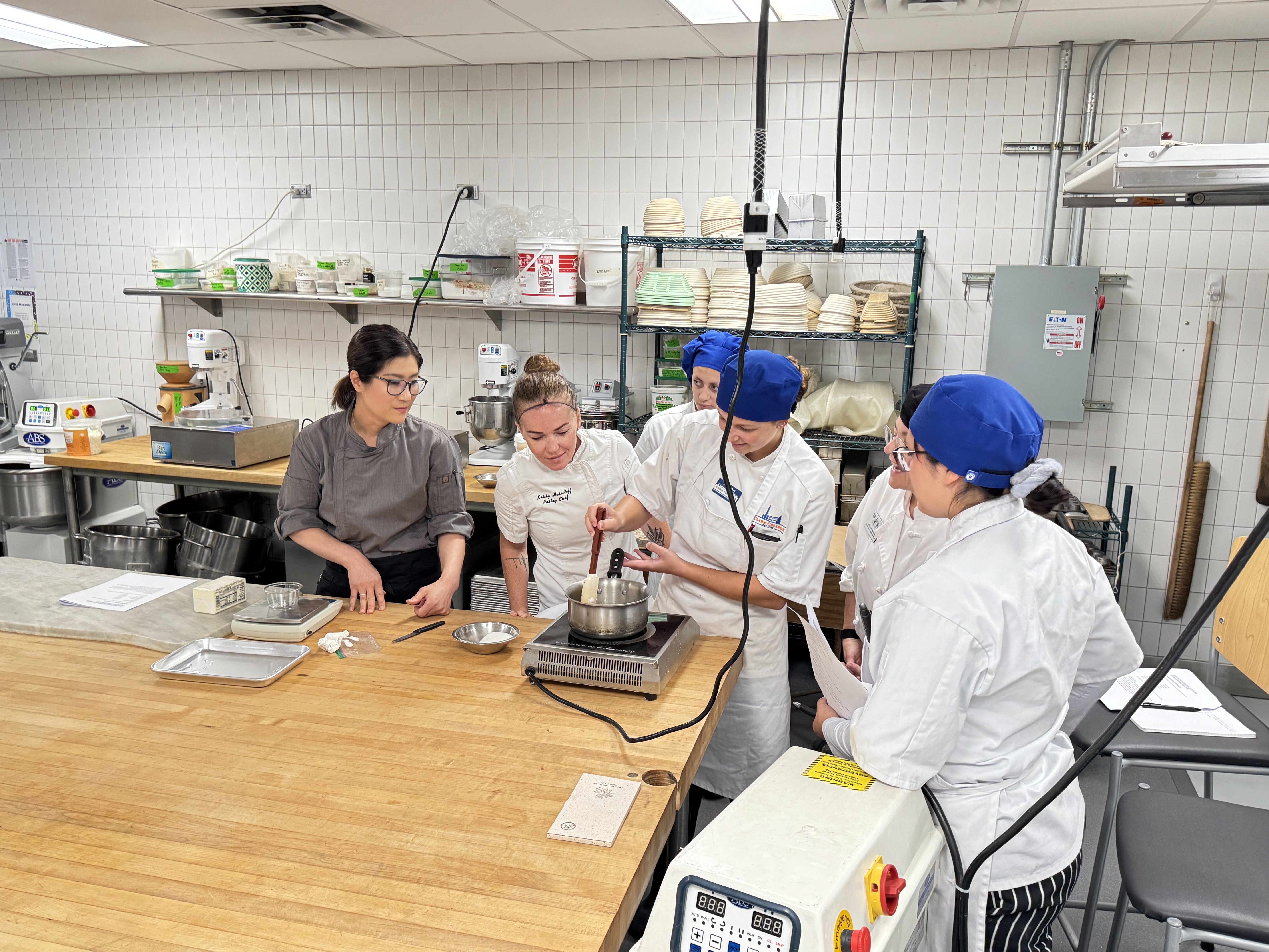 A group of baking students work with award-winning chocolatier in Clark's culinary institute 