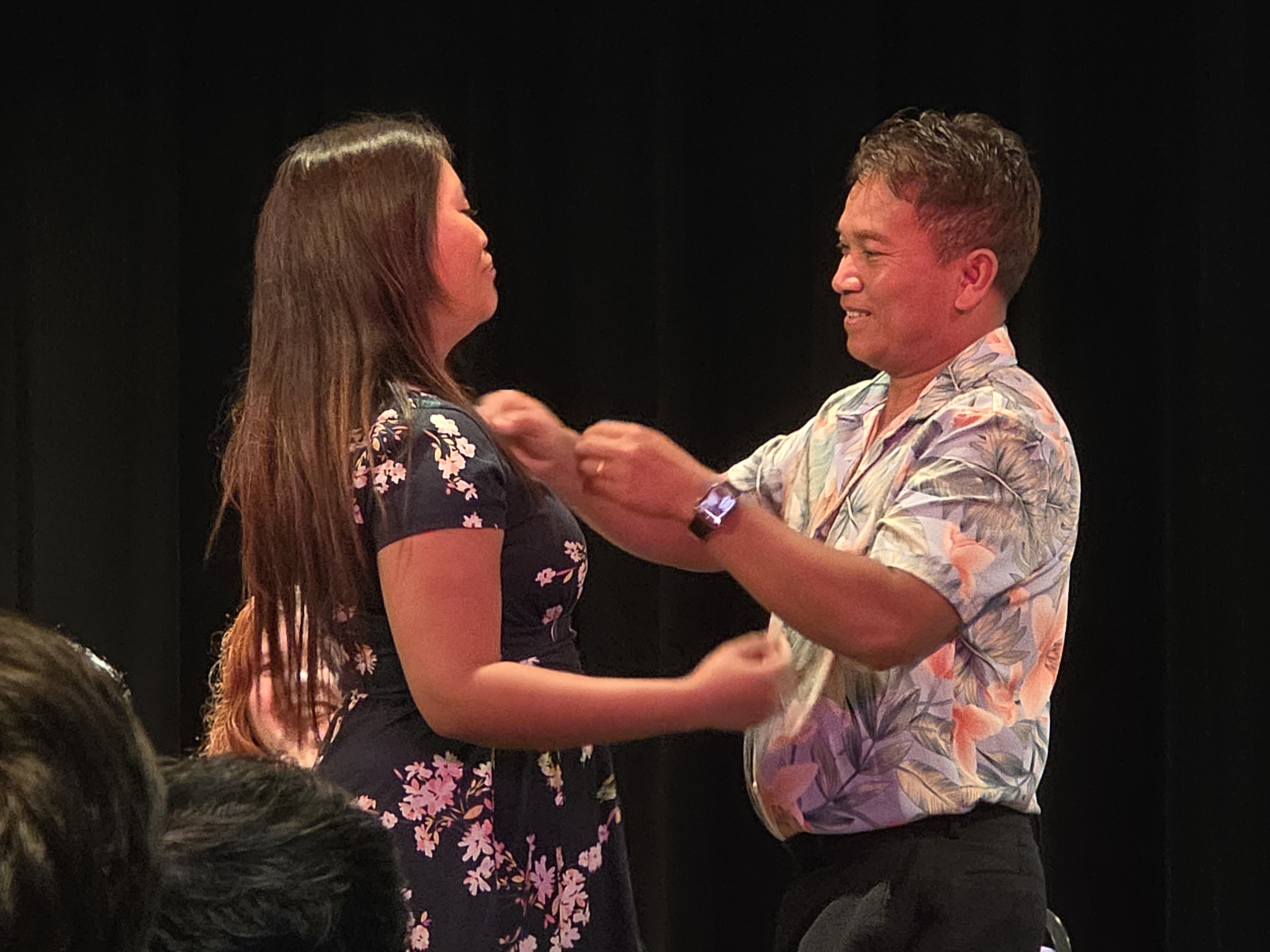 Medical assisting graduate receiving pin from loved one