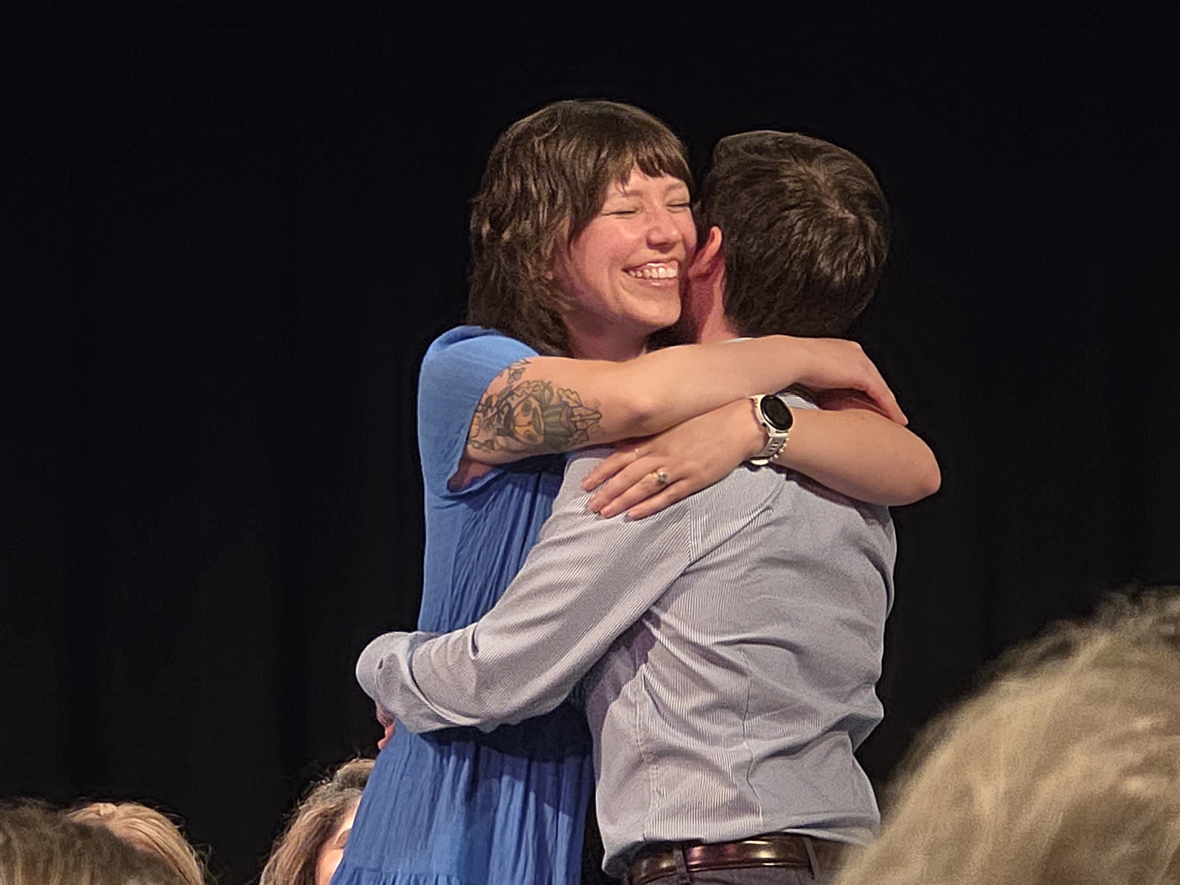 Medical assisting graduate hugging a loved one