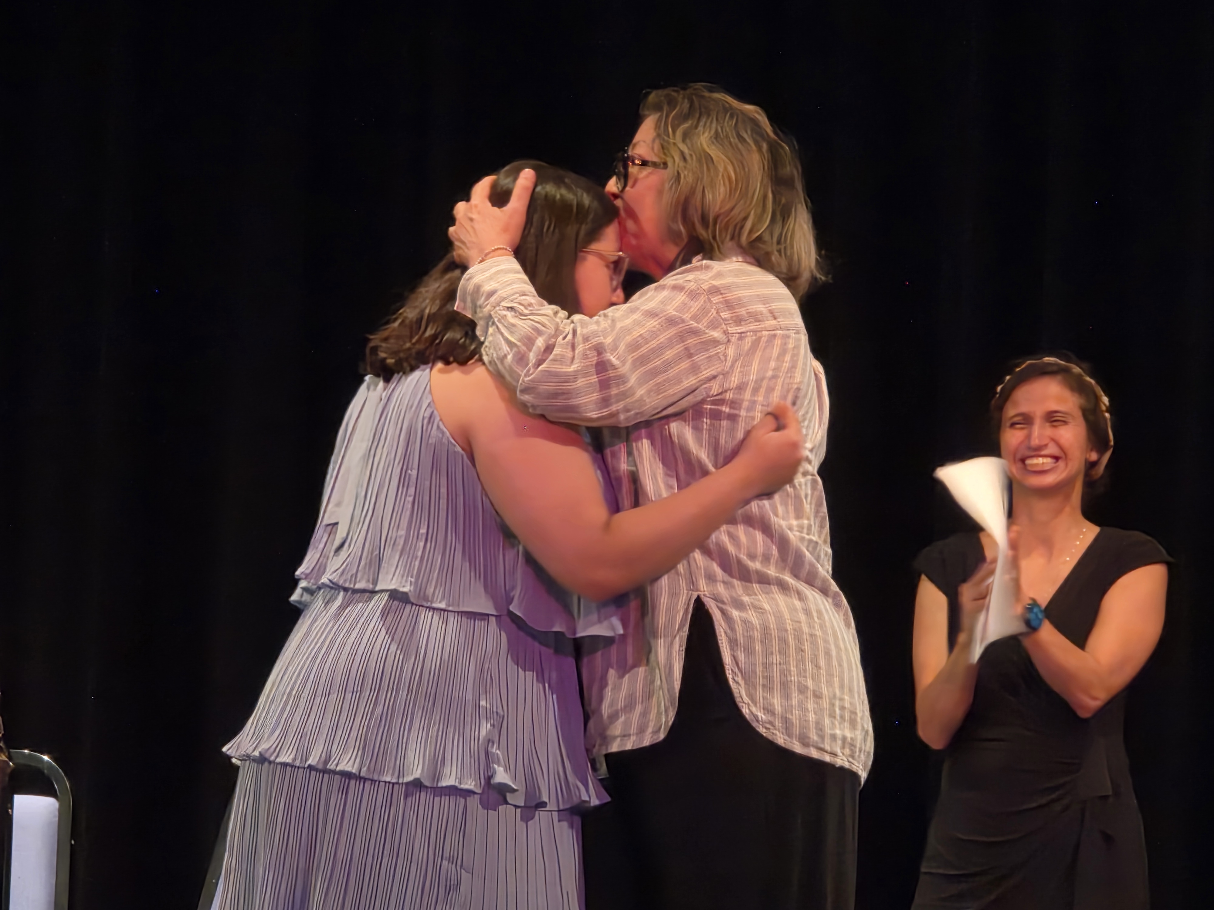 Medical assisting graduate hugging a loved one