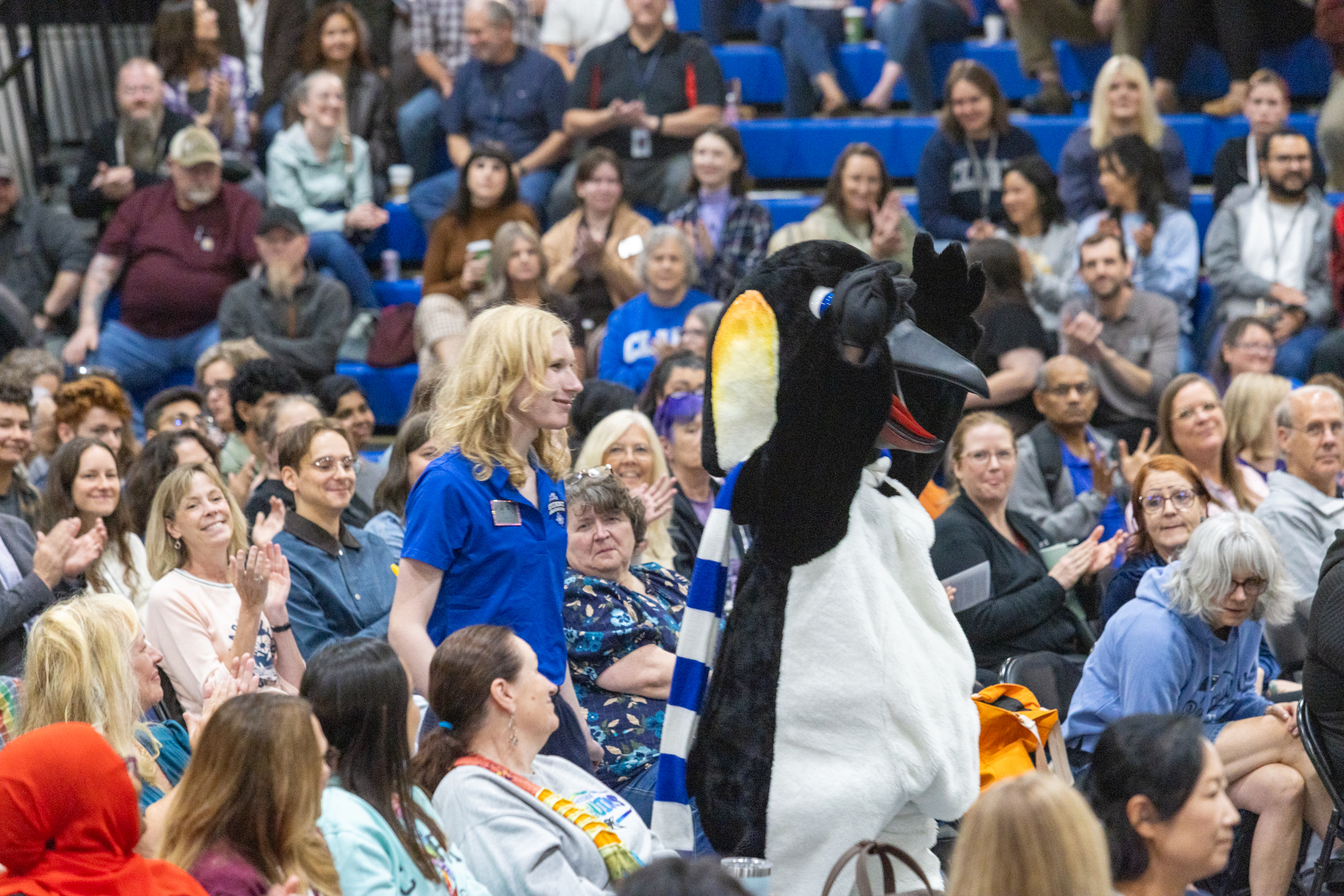 Oswald walks through the crowd with his student handler