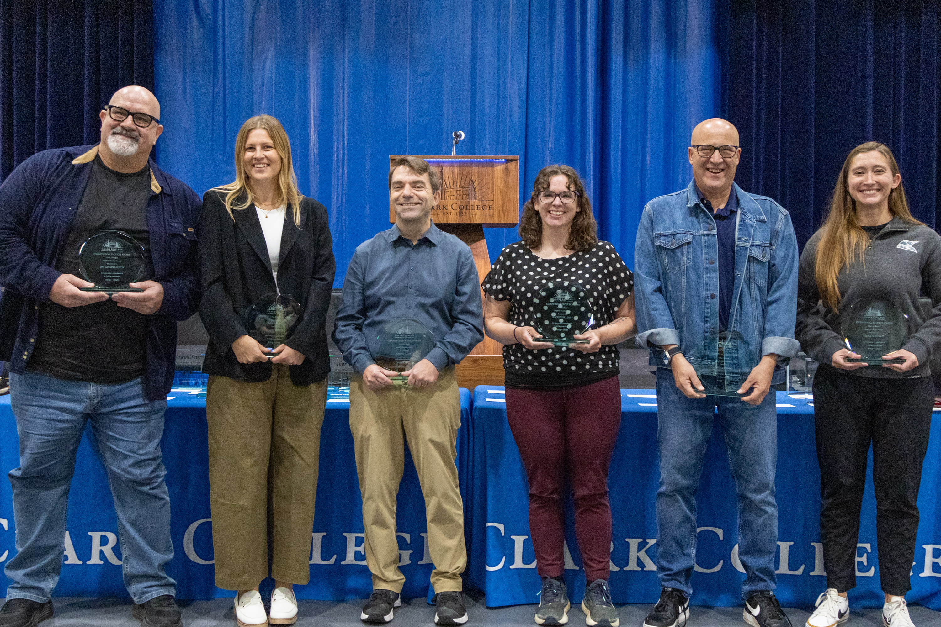 Exceptional Faculty award winners stand holding their awards