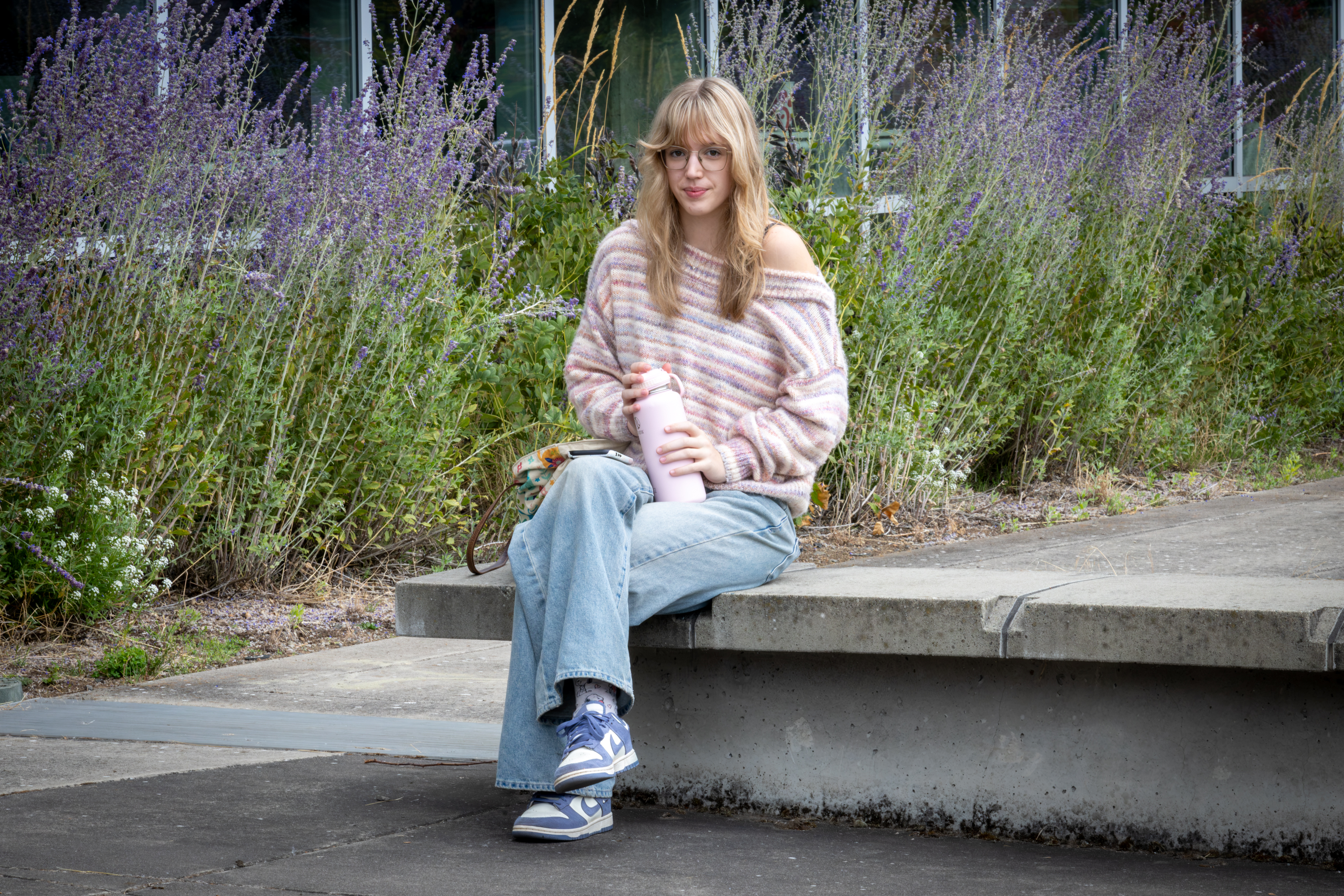 Student sits in Friendship Garden