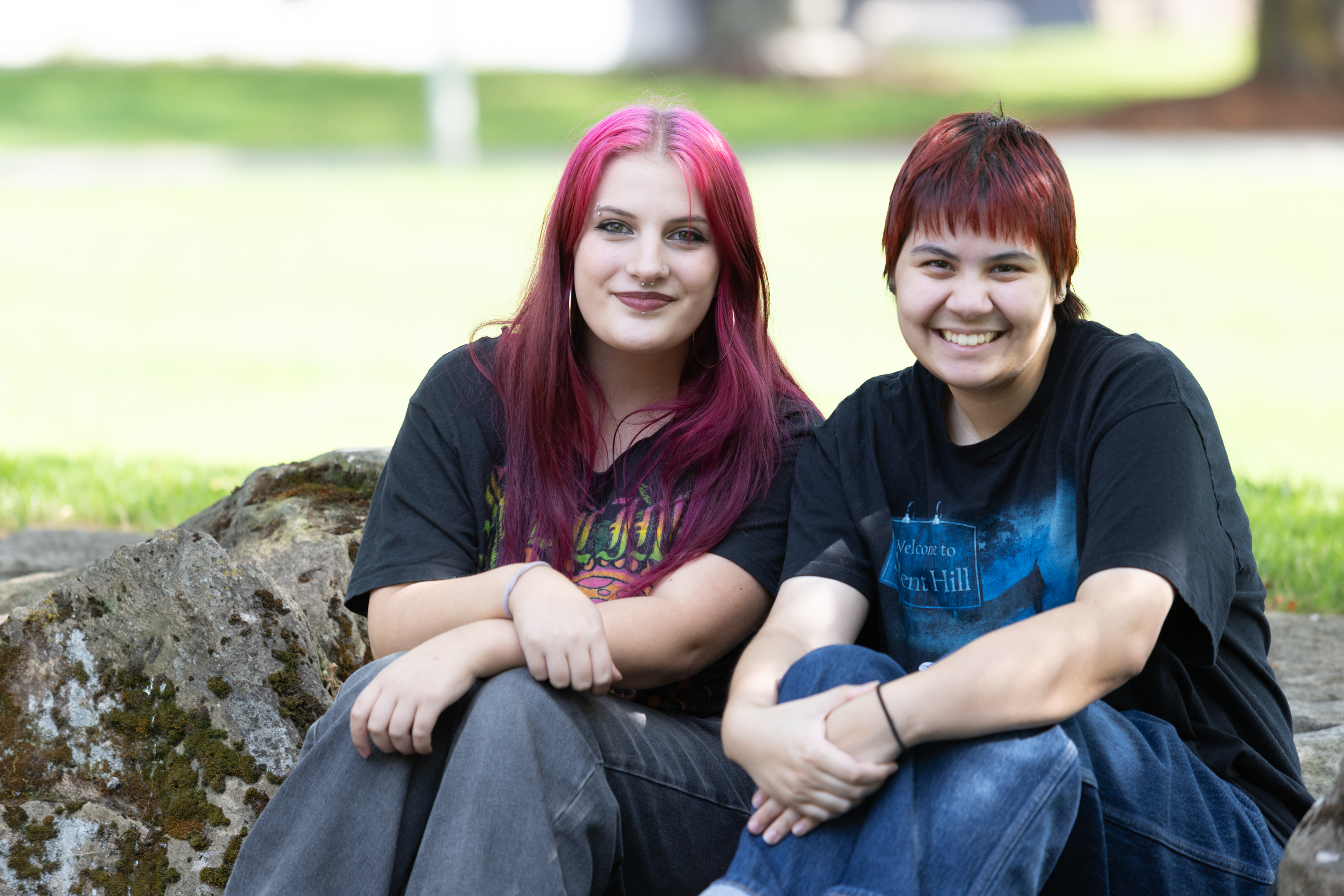 Two students sit together outside