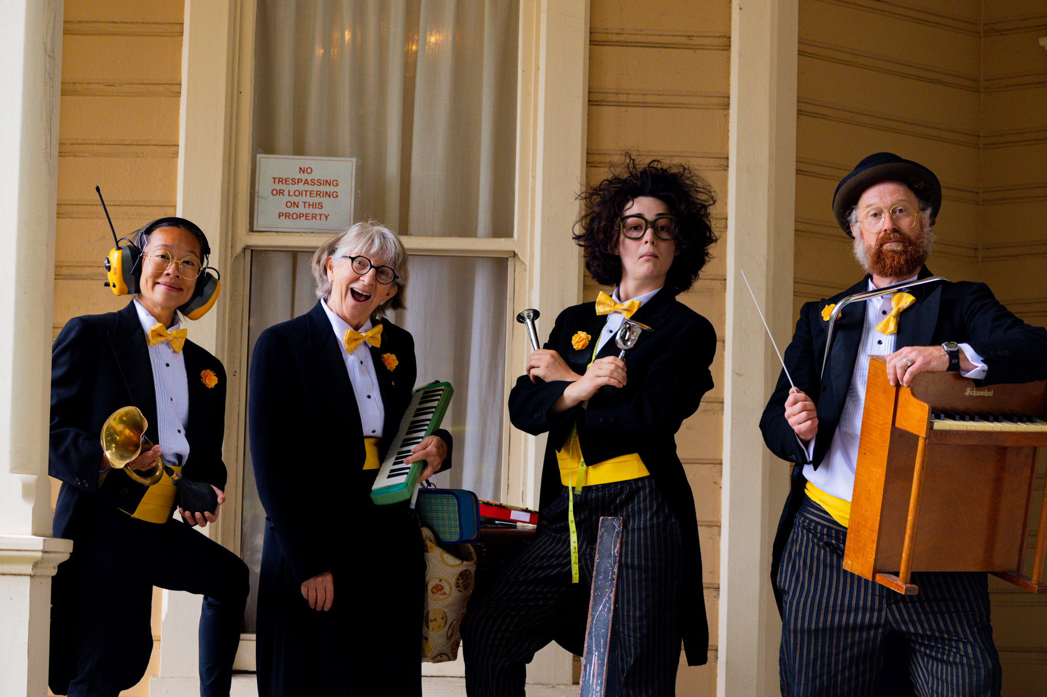 Four jazz musicians in tuxedos posing for photos