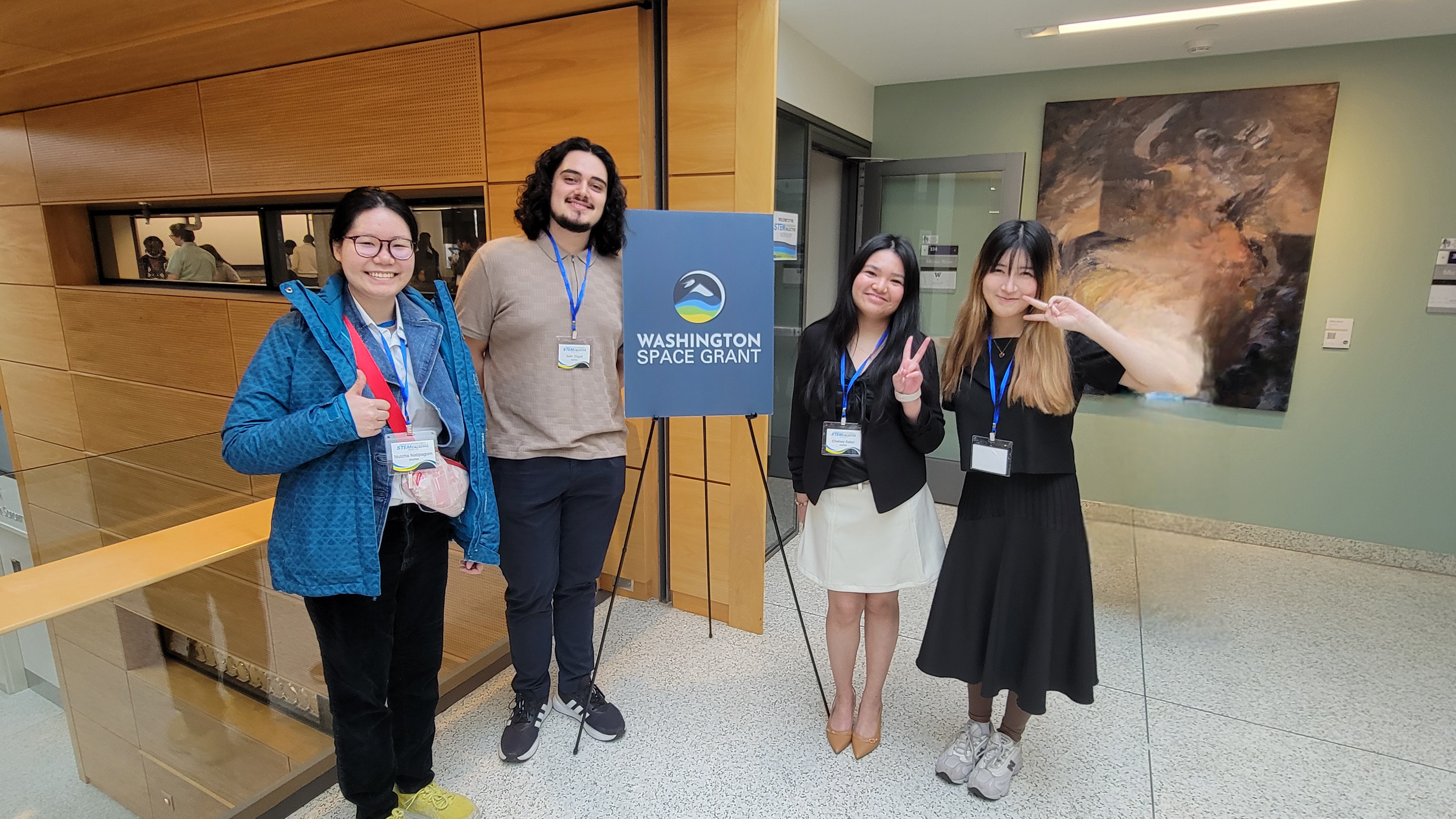 MESA students standing in front of a sign at the STEM Leadership Collective Workshop