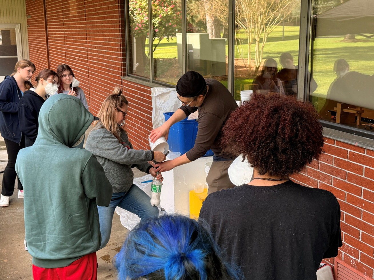Nan Curtis and Professor Colin Kippen demonstrate plaster casting to students