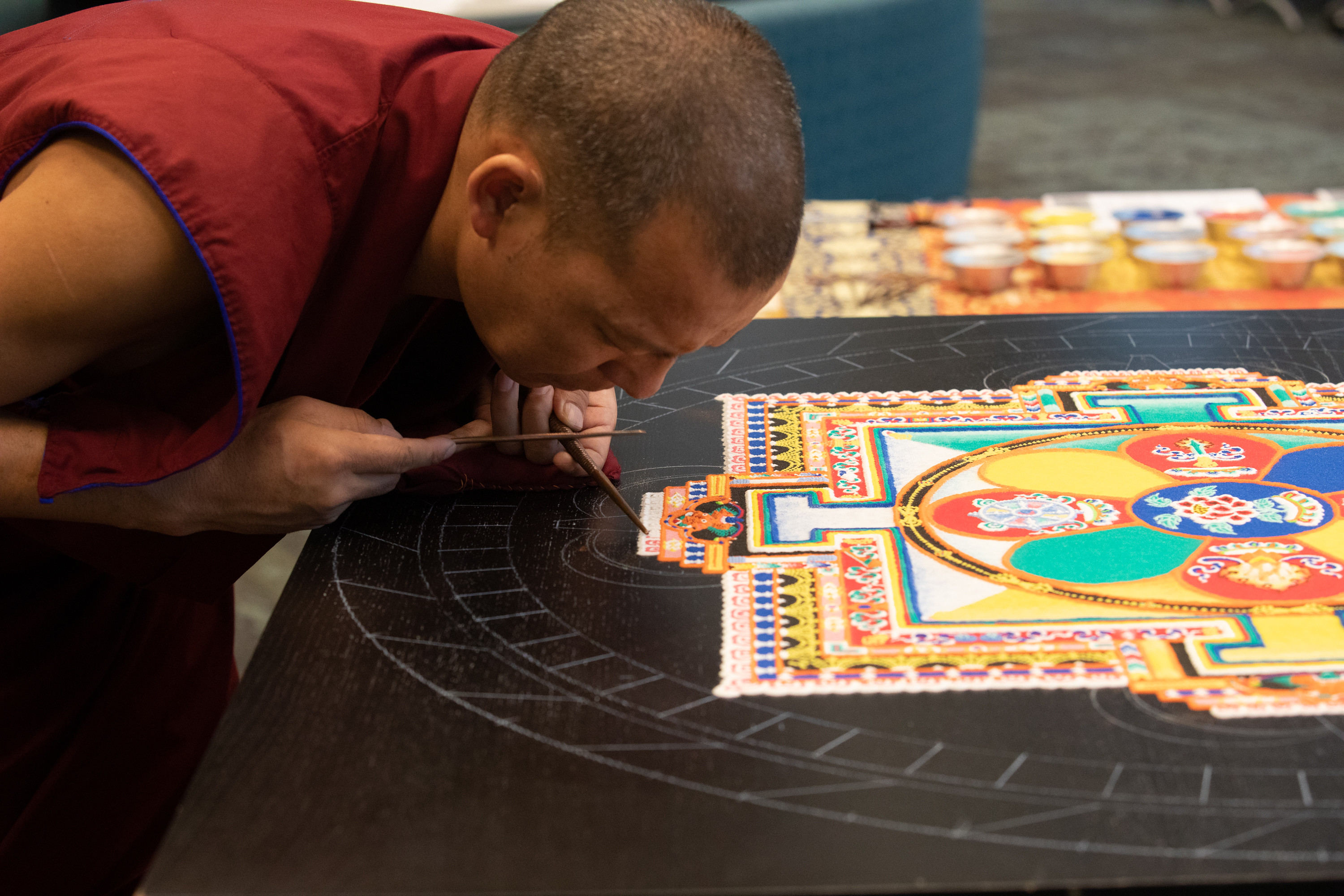 Monk creating sand mandala