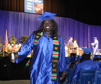 A 2005 Clark College graduate celebrates receiving her diploma