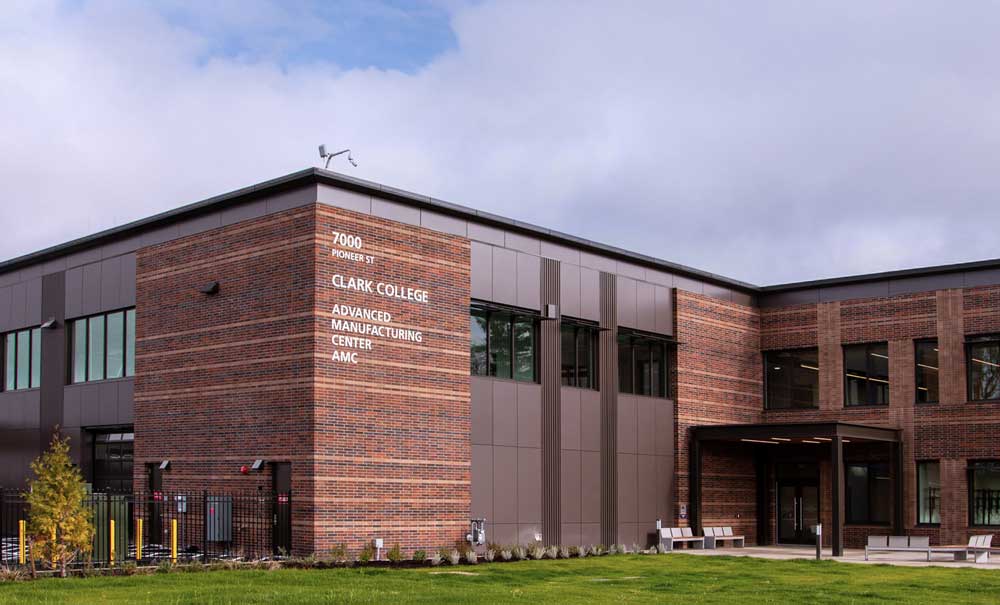 Large building with the words 'Clark College, Advanced Manufacturing Center AMC'