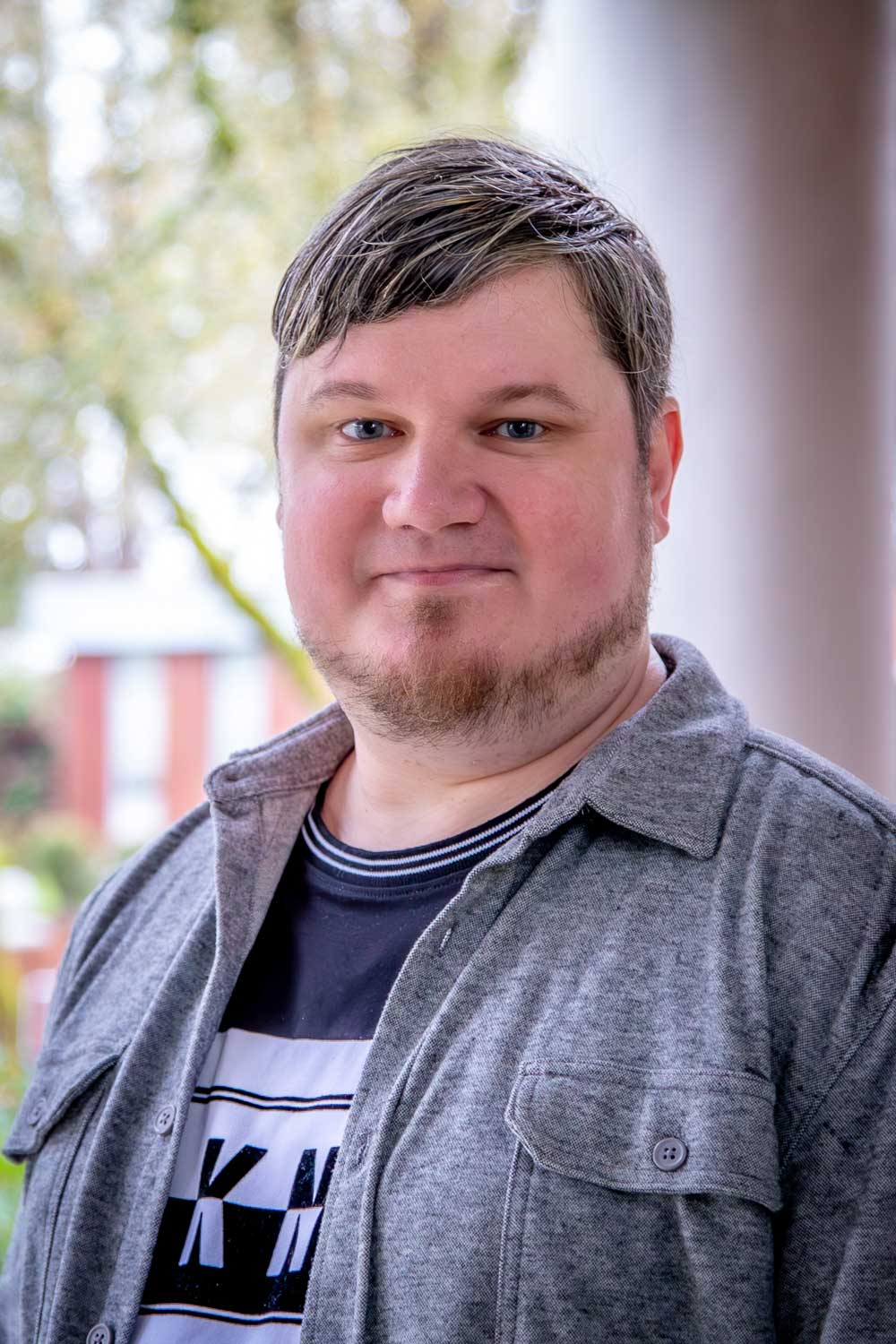 Headshot of a student, Anton Vlasov, smiling.