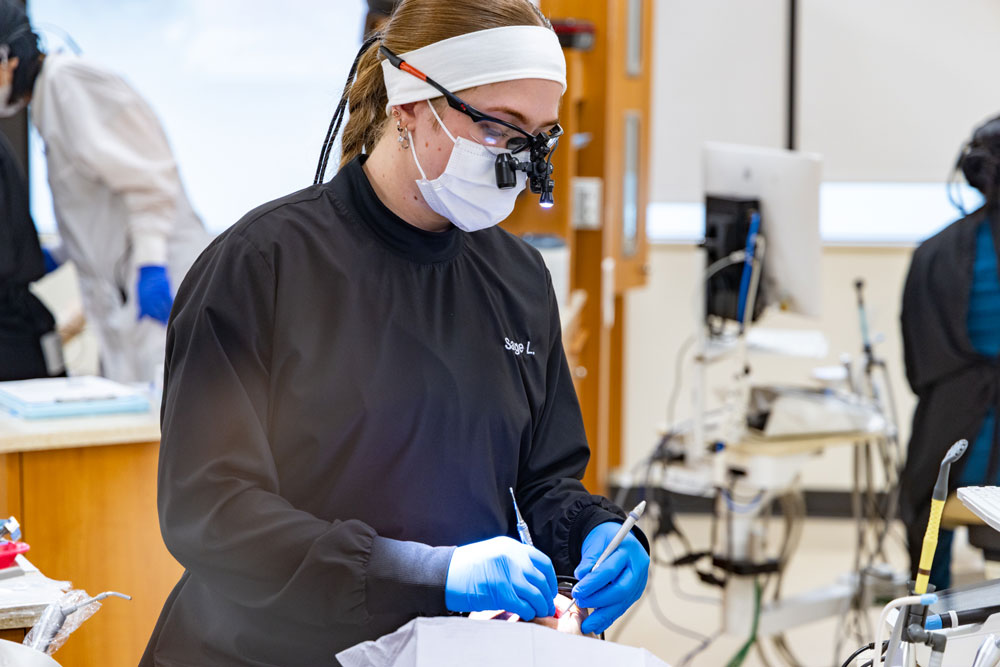 Dental hygienist working on patient's teeth