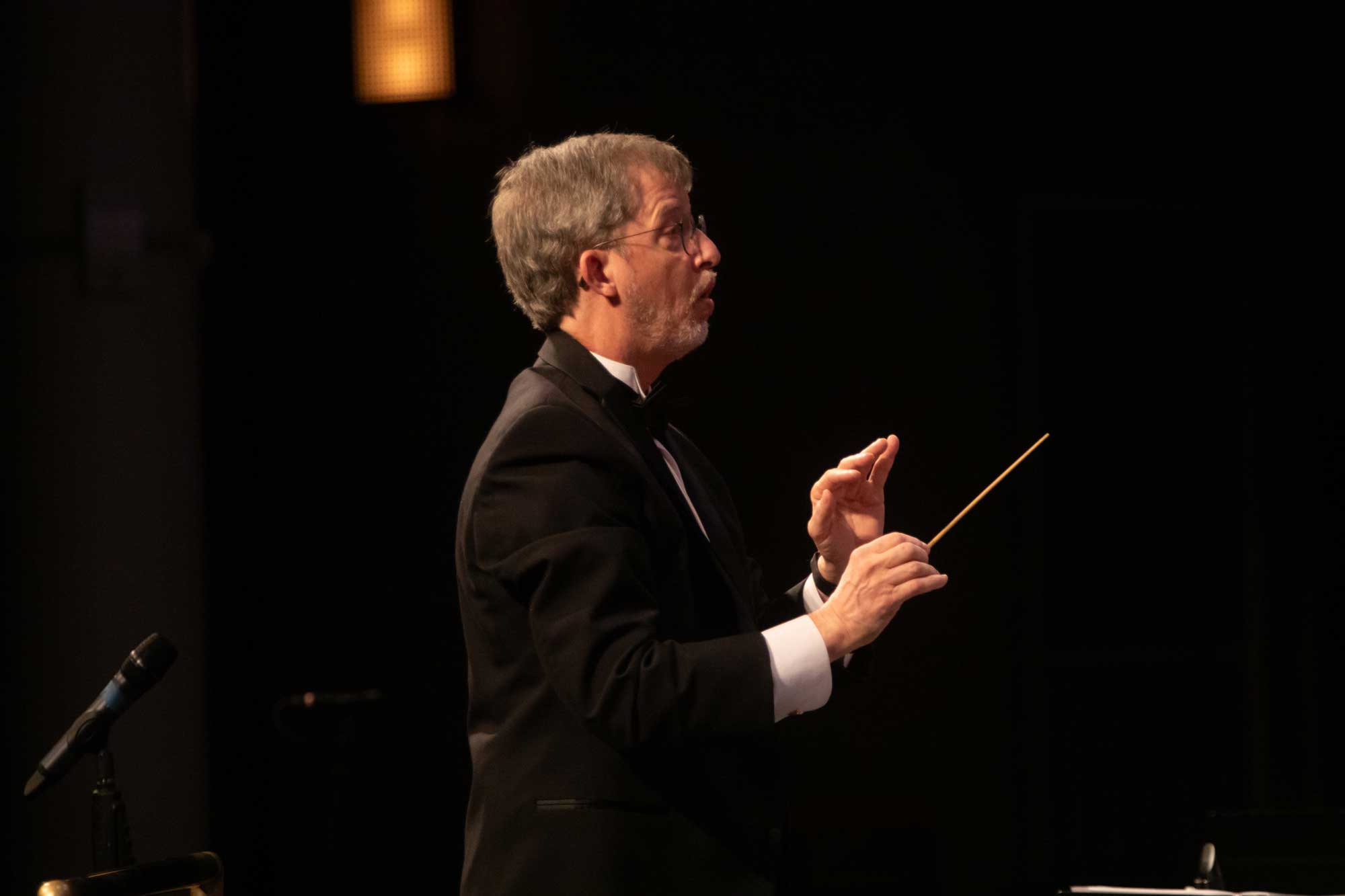 A conductor directs a concert band.