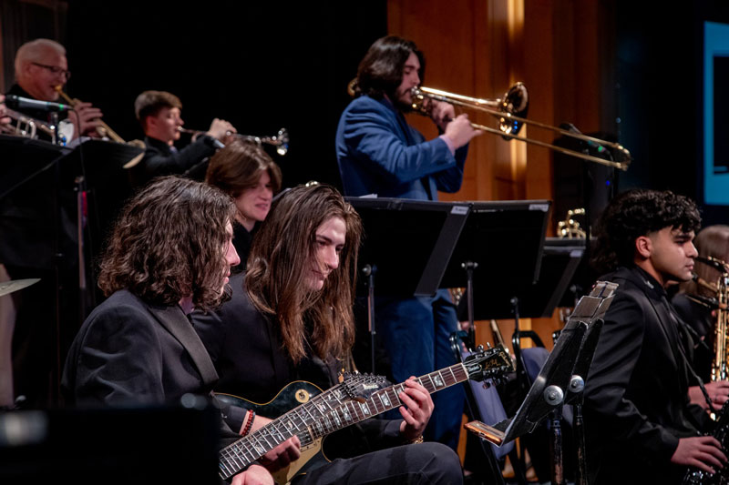 Student musicians from the ensemble playing together.