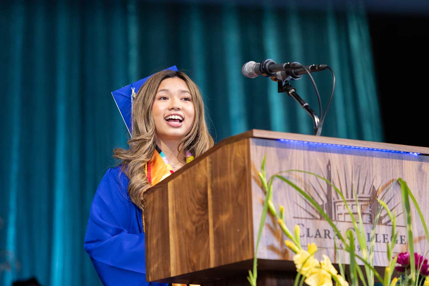 Graduating student speaker Malina Siharath giving her speech on the podium.