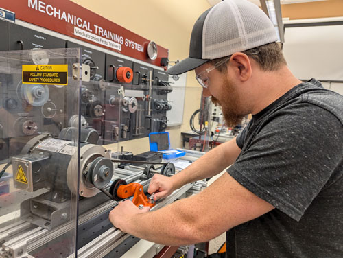 An MTX machinist student at Sigma Design completing the lab project on a mechanical training system