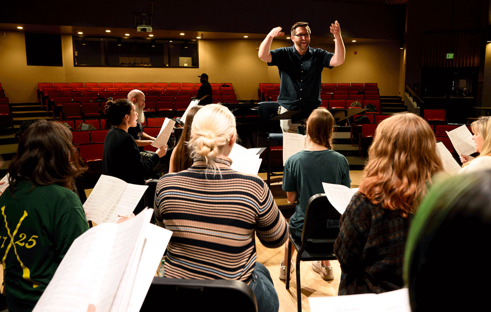 A conductor directs a choir ensemble.