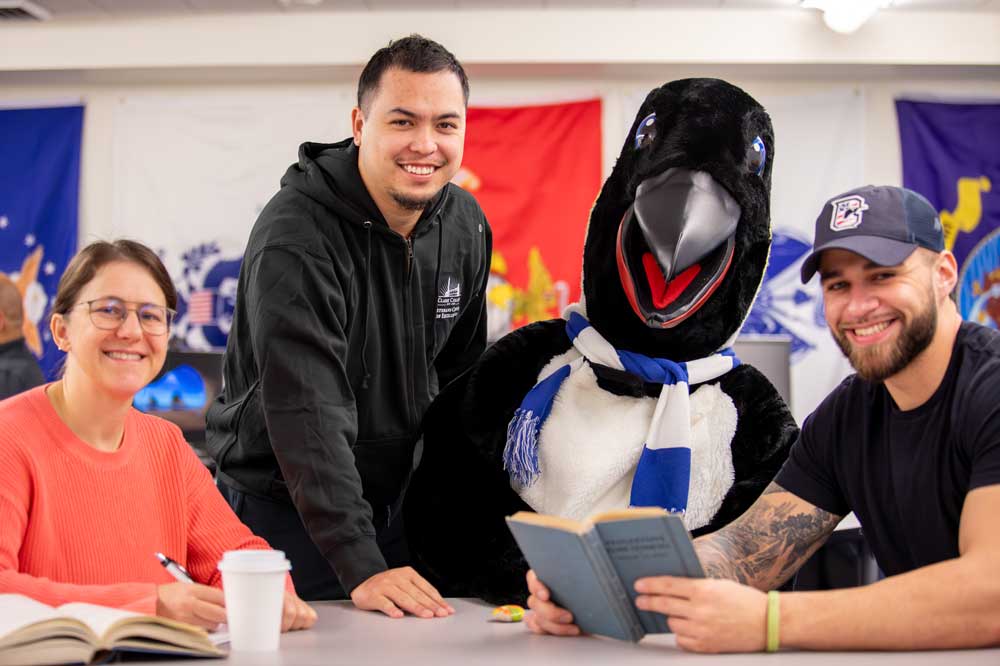 Students posing with the school mascot.