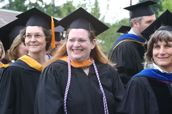Clark College faculty members smile at graduates as they enter the Clark College Amphitheater for Commencement 2006.