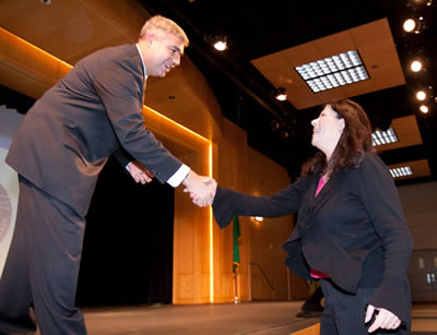 President Knight presents a Presidential Coin to Janet Owens, Administrative Assistant in Corporate and Continuing Education