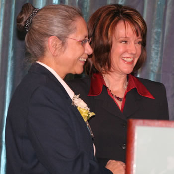 Emcee Laural Porter congratulates Sister Joelle Aflague, a 2007 Woman of Achievement.