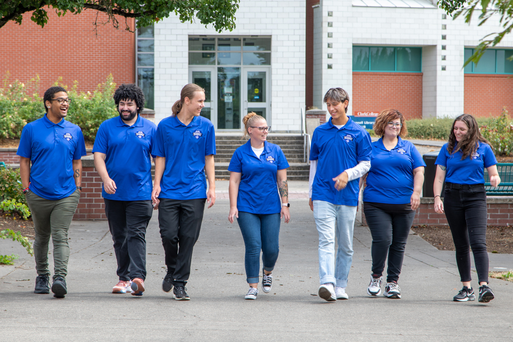 Students walking on campus, talking and laughing